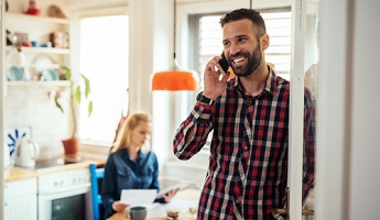 man discussing life insurance policy on his mobile phone