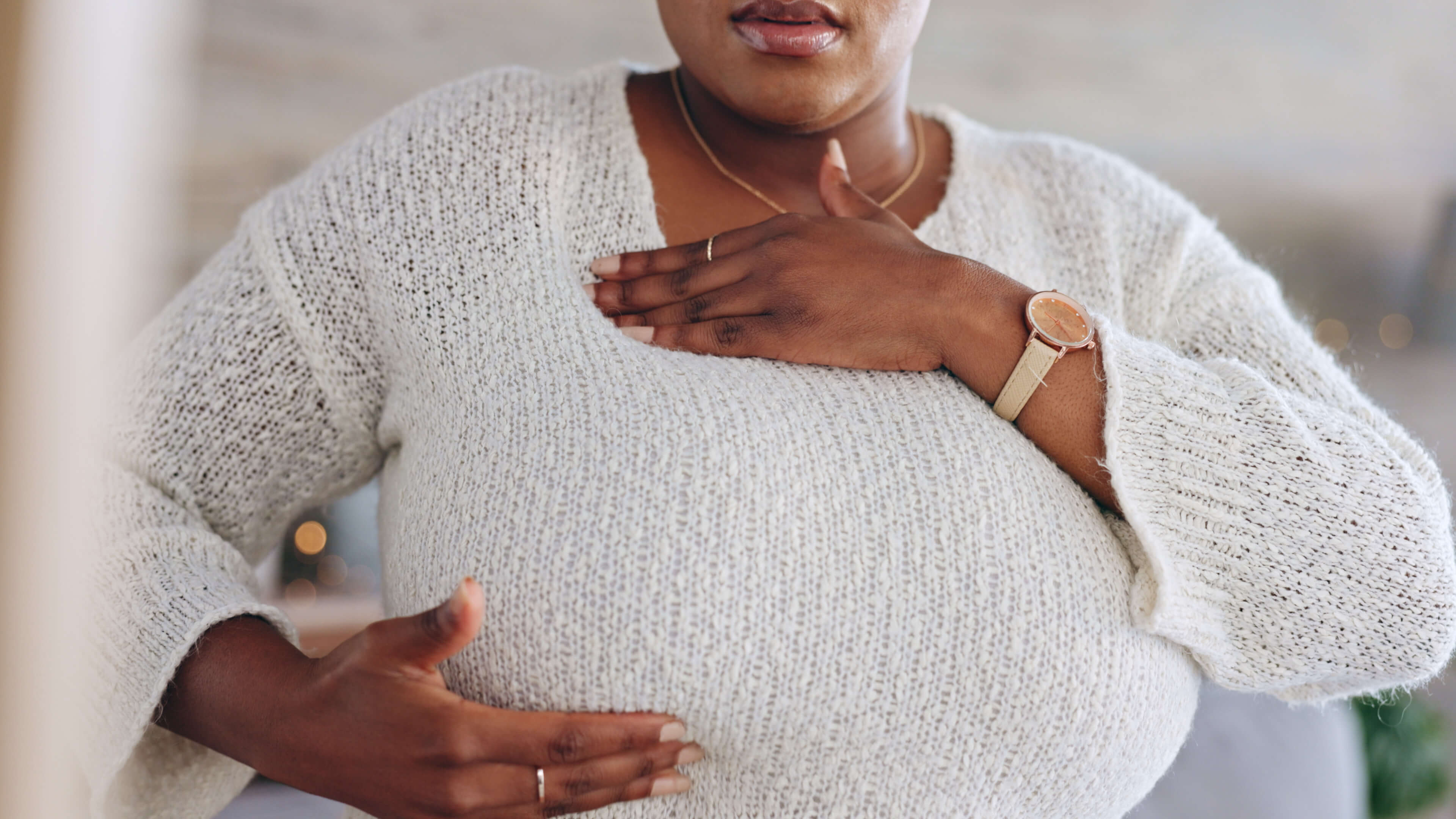Woman holding her breast checking for breast cancer
